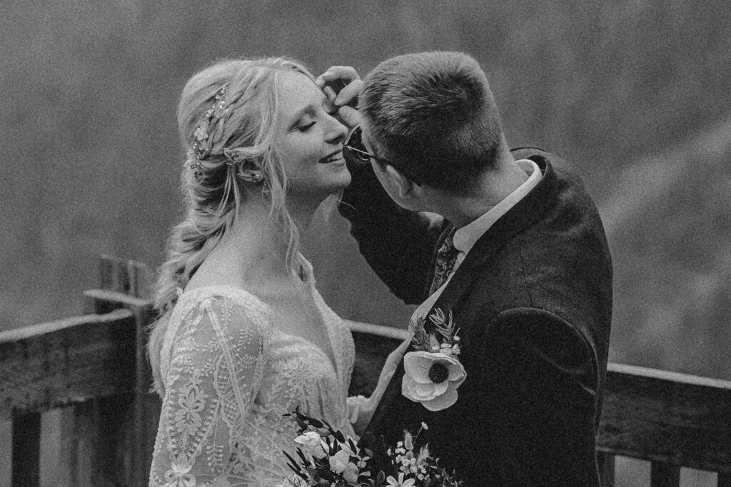 groom fussing over brides lashes