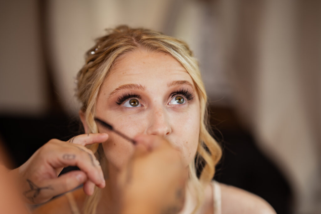 bride getting makeup done