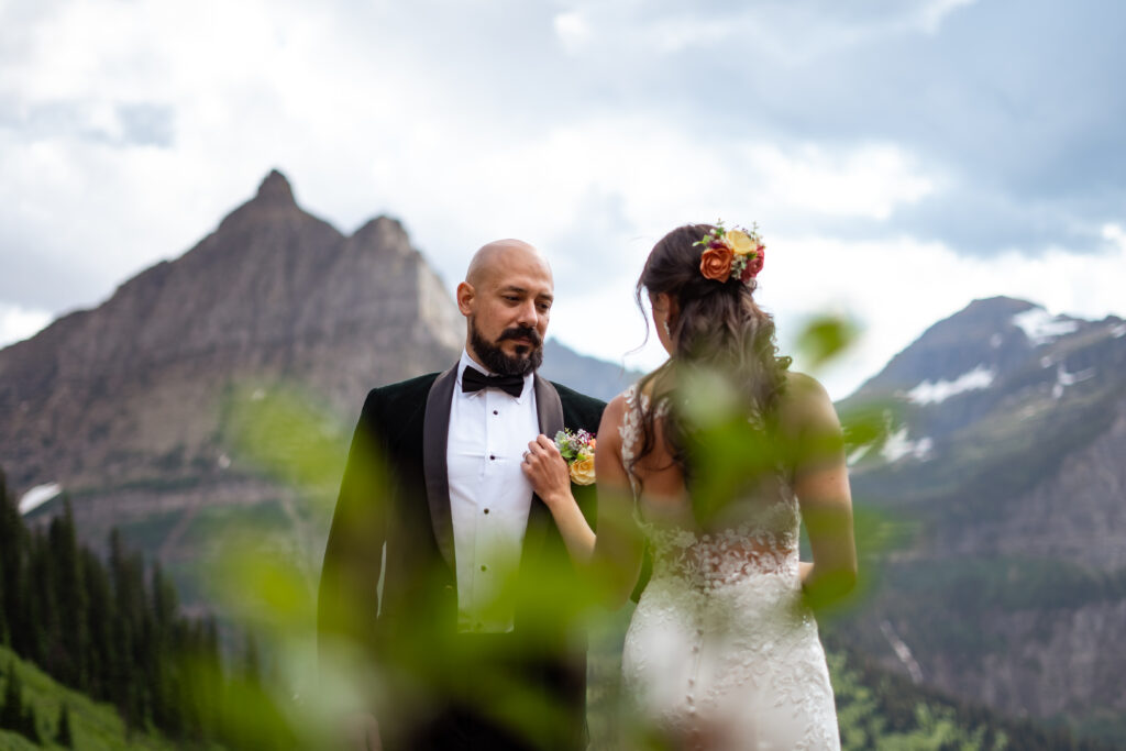 Bride and groom in artistic shot in the mountains.