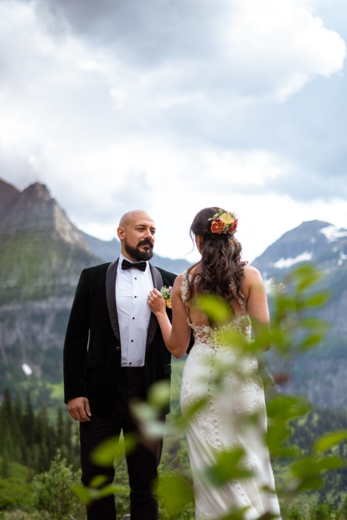 Bride touching groom chest.