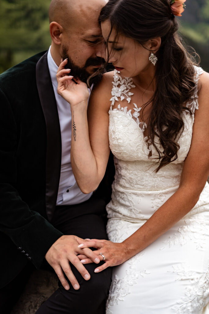 bride and groom touching intimately.