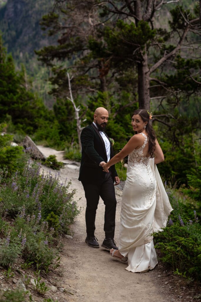 Couple hiking through the trail during elopement