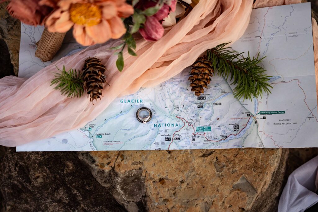 Elopement details shot including maps, rings, and florals.