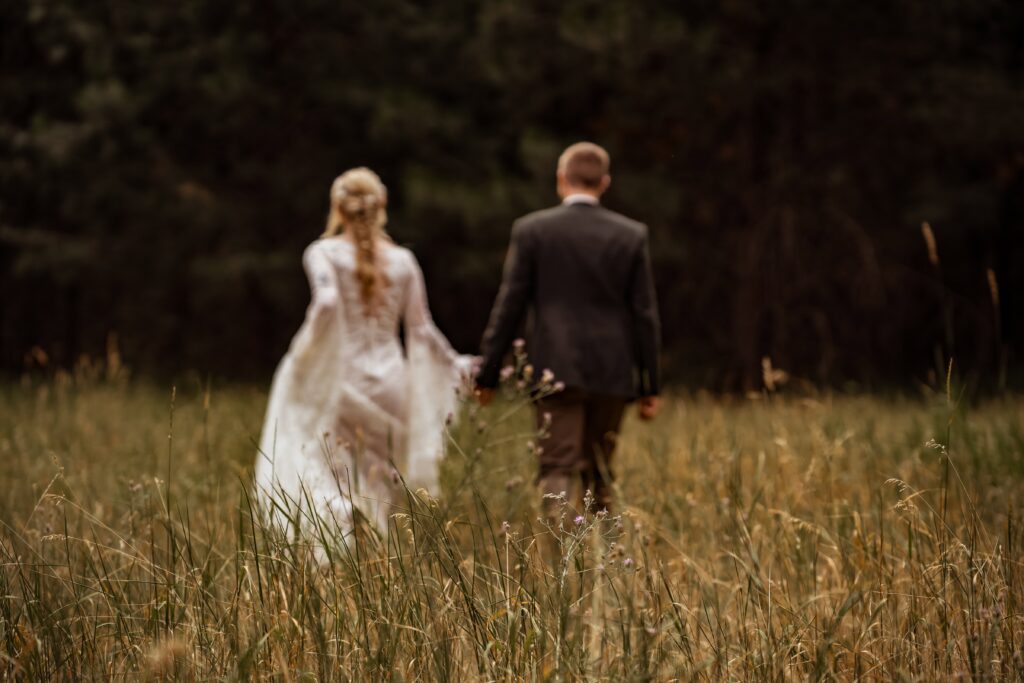 Couple on their way to elope in a grassy field in Montana