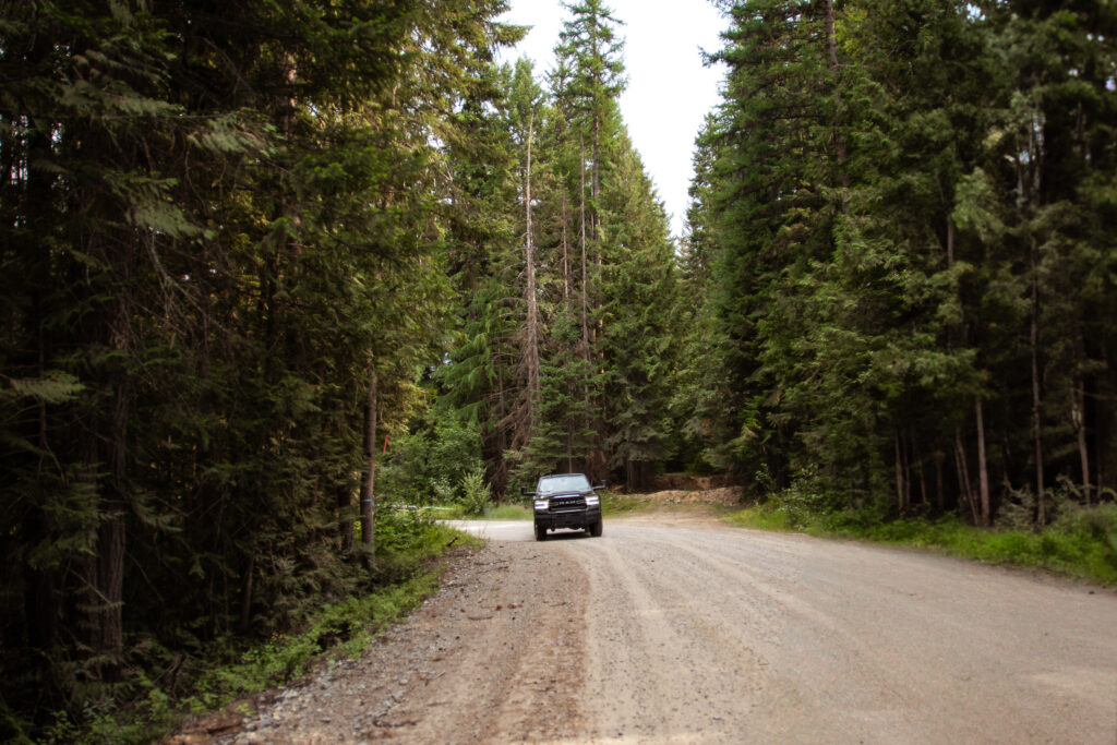 truck driving down a dirt road.